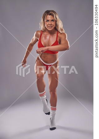 Muscular woman doing fitness in red sport underwear 106330494