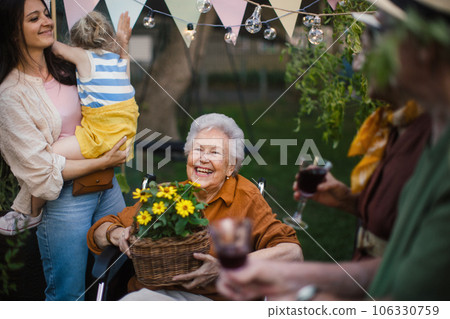 Family haivng party during warm summer evening in urban garden Family haivng party during warm summer evening in urban garden 106330759
