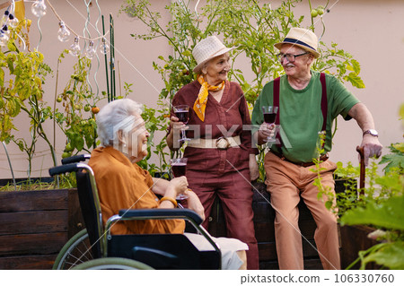 Portrait of senior friends relaxing after hard work in urban garden. Portrait of senior friends relaxing after hard work in urban garden. 106330760
