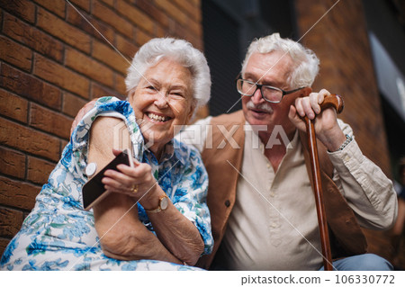 Diabetic senior woman checking blood glucose level with continuous glucose monitor outdoors in the city 106330772