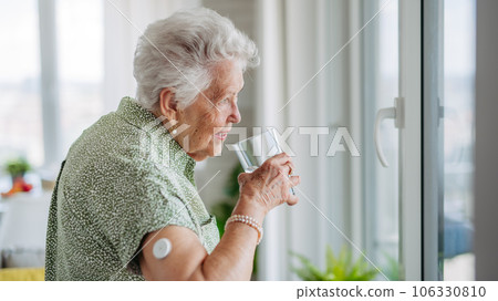 Senior woman drinking water to better manage her diabetes. Senior woman drinking water to better manage her diabetes. 106330810