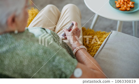 Diabetic senior patient injecting insulin in her belly. 106330819