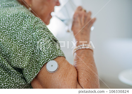 Senior woman drinking water to better manage her diabetes. 106330824