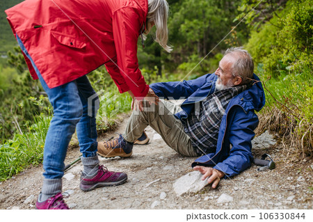 Senior man injured his leg during hike in the mountains. Senior man injured his leg during hike in the mountains. 106330844