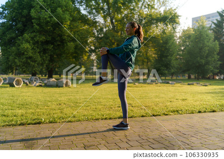 Full lenght portrait of beautiful fitness woman stretching before morning outdoor workout in the city park. Full lenght portrait of beautiful fitness woman stretching before morning outdoor workout in the city park. 106330935