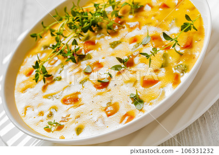 Beer cheese soup with vegetables and thyme 106331232