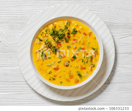 Beer cheese soup with vegetables and thyme 106331233