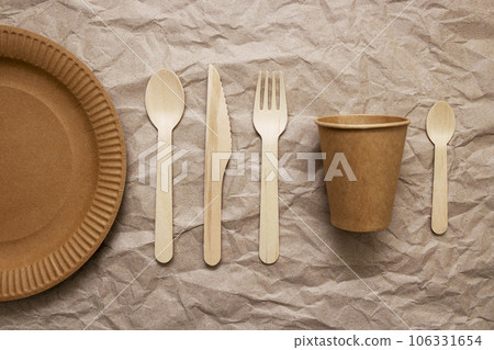 A set of disposable tableware on a paper background 106331654