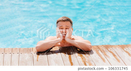 Portrait of a sad and dreamy middle-aged man in the pool at the side. 106331745