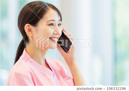 Medical worker making a call on a smartphone 106332296