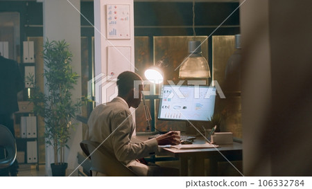 Employee enjoying cup of coffee while imputing financial datasets on computer during nightshift, helped by supervisor. Accountant working in office under manager guidance 106332784