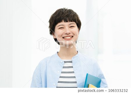 Portrait of female college student with files Portrait of female college student with files 106333232