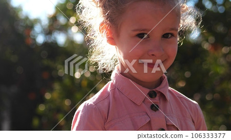 Close-up portrait of a beautiful shy little girl 106333377