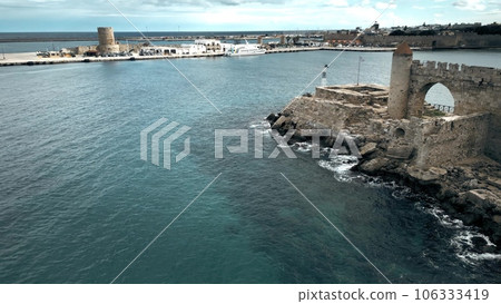 Low altitude aerial view of the ancient fortress wall and ferry port in old town of Rhodes, Greece 106333419