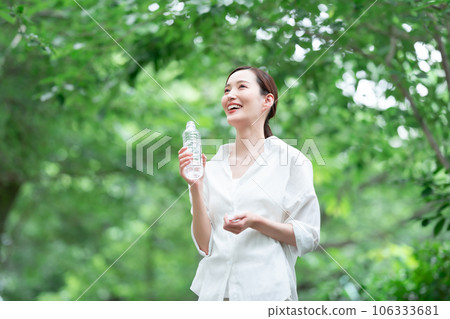 A woman drinking water A woman drinking water 106333681