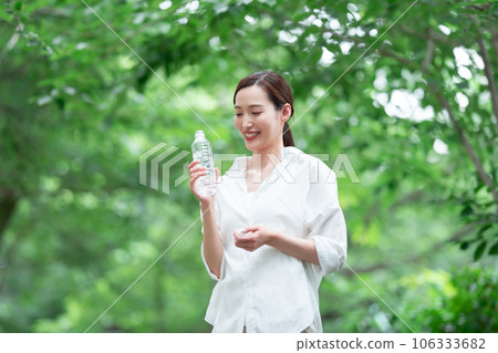 A woman drinking water A woman drinking water 106333682