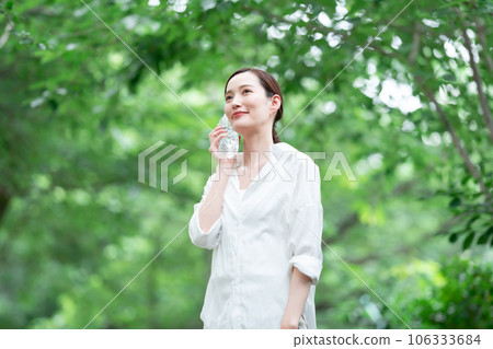 A woman drinking water A woman drinking water 106333684