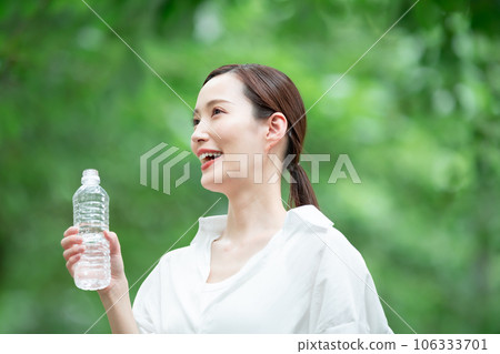 A woman drinking water 106333701