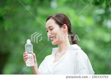 A woman drinking water 106333703