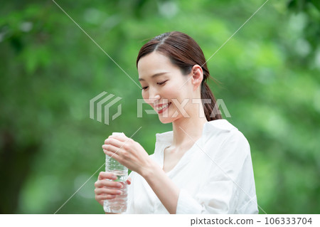 A woman drinking water 106333704