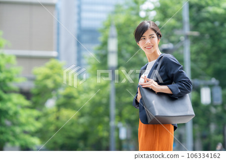 Young business woman in office casual commuting to office district 106334162