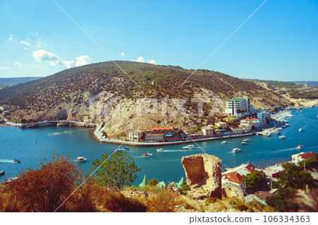 an ancient stone tower on a blue sky background 106334363