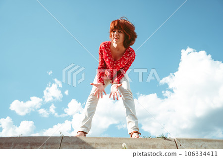 the girl looks at the camera in surprise 106334411