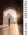 tourist standing in front entrance gate of Taj Mahal indian palace. Islam architecture. Door to the mosque  106334762