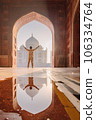 tourist standing in front entrance gate of Taj Mahal indian palace. Islam architecture. Door to the mosque  106334764