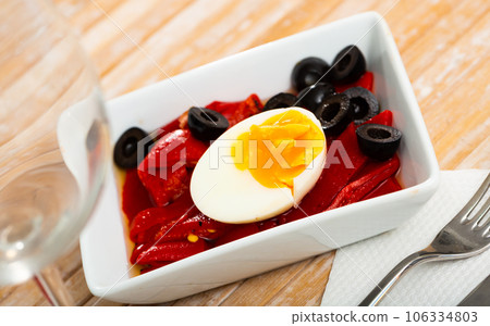 Platter with stewed peppers and half boiled egg Platter with stewed peppers and half boiled egg 106334803