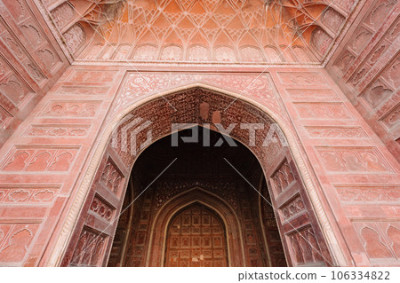 entrance gate of The Taj Mahal is an architectural masterpiece and one of the most iconic landmarks in the world. 106334822