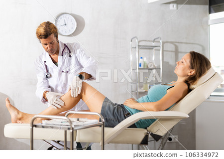 Doctor in medical gloves exam woman's legs. Doctor in medical gloves exam woman's legs. 106334972