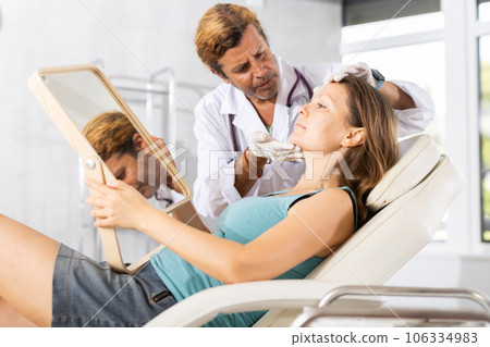 Cosmetologist giving professional advice before facial skin treatments to woman Cosmetologist giving professional advice before facial skin treatments to woman 106334983