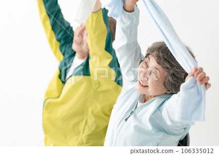 Senior stretching with a towel 106335012