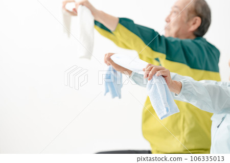 Senior stretching with a towel 106335013