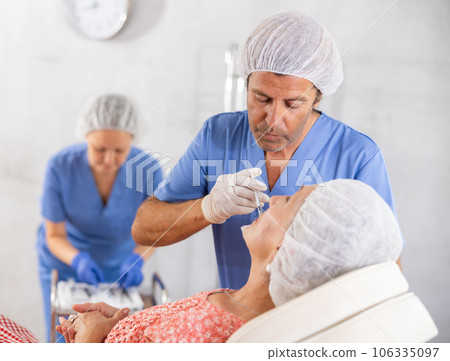 Senior woman getting lip fillers in aesthetic medicine office Senior woman getting lip fillers in aesthetic medicine office 106335097