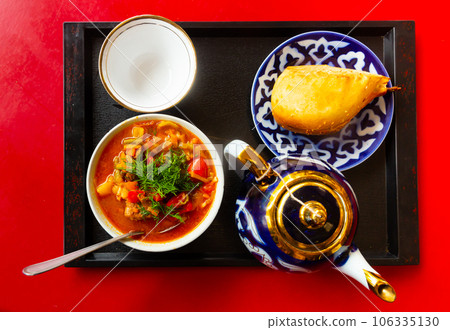 Uzbek soup laghman served with samsa 106335130