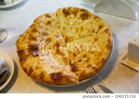 Traditional dish of Georgian cuisine is Khachapuri flatbread with cheese Traditional dish of Georgian cuisine is Khachapuri flatbread with cheese 106335158