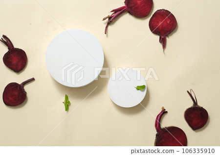 A set of white podiums in round-shaped displayed with beetroot and green leaves. Modern minimal showcase scene for cosmetic products promotion 106335910
