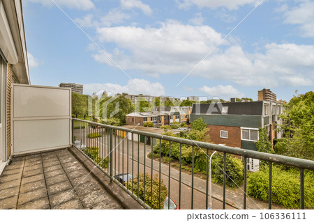 a balcony with some trees and buildings in the background, taken from an apartment window looking out onto the street a balcony with some trees and buildings in the background, taken from an apartment window looking out onto the street 106336111