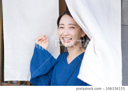 Woman passing through the noren Japanese restaurant dining out Woman passing through the noren Japanese restaurant dining out 106336155
