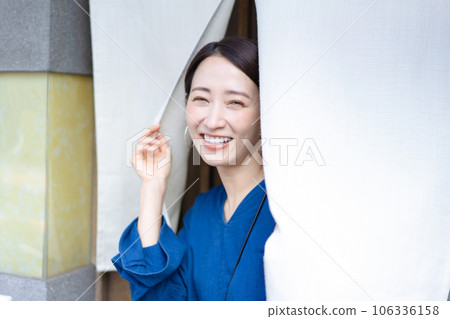 Woman passing through the noren Japanese restaurant dining out 106336158