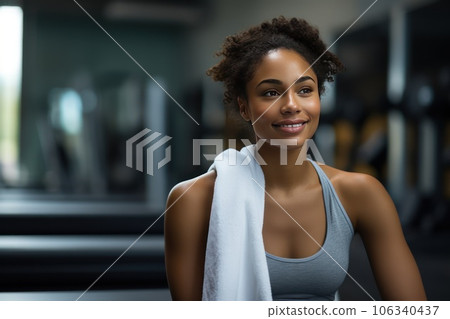 Beautiful young female athlete bodybuilder, sitting in the gym, resting after the crossfit. Beautiful young female athlete bodybuilder, sitting in the gym, resting after the crossfit. 106340437