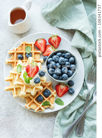 Freshly baked waffles with strawberries and blueberries 106341737