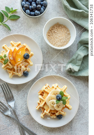 Belgian waffles with fruit, bananas and honey. Homemade baking. 106341738