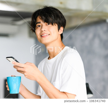 A young man drinking coffee A young man drinking coffee 106341740
