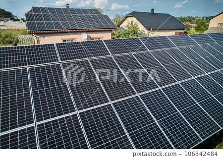 Aerial top view of new modern house cottage with solar photovoltaic panel system on house roof 106342484