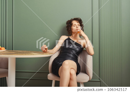 Woman inhales aroma of wine 106342517