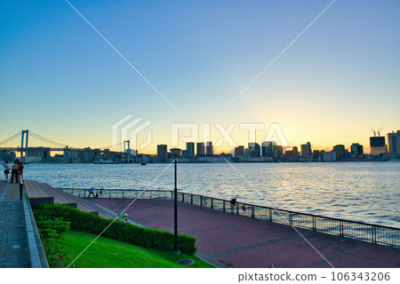Evening view of Rainbow Bridge seen from Toyosu Gururi Park 106343206