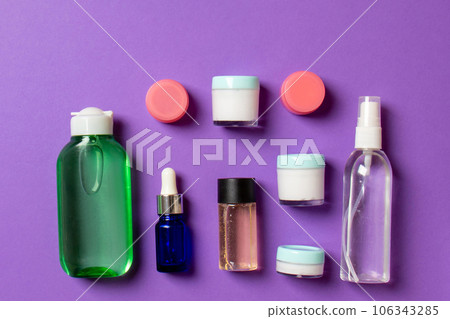 Cosmetics SPA branding mock-up, top view with copy space. set of tubes and jars of cream flat lay on colored background 106343285